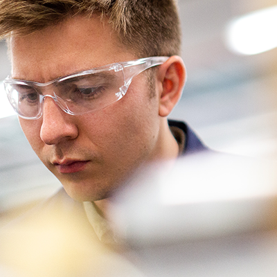 Scientist in safety googles at lab bench